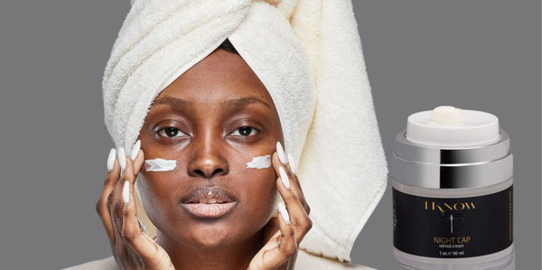 African American woman applying IKNOW Night Cap Retinol Cream