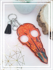 Bright orange and black glitter resin raven skull keyring