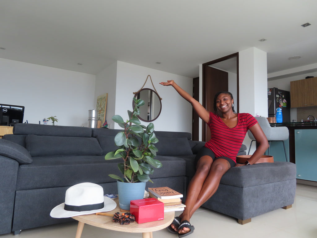 Solo traveler sitting on Airbnb couch in Medellin Colombia
