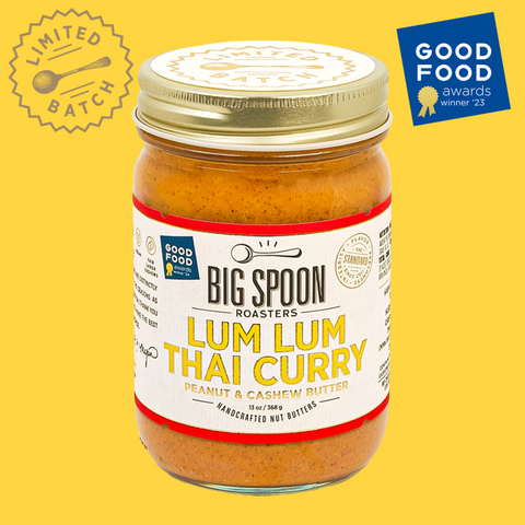 A jar of Lum Lum Thai Curry nut butter against a yellow background with a Goo