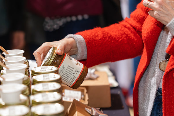 A shopper looks at a jar of Big Spoon Nut Butter