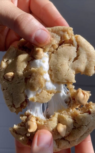 A person pulls apart a fluffernutter cookie