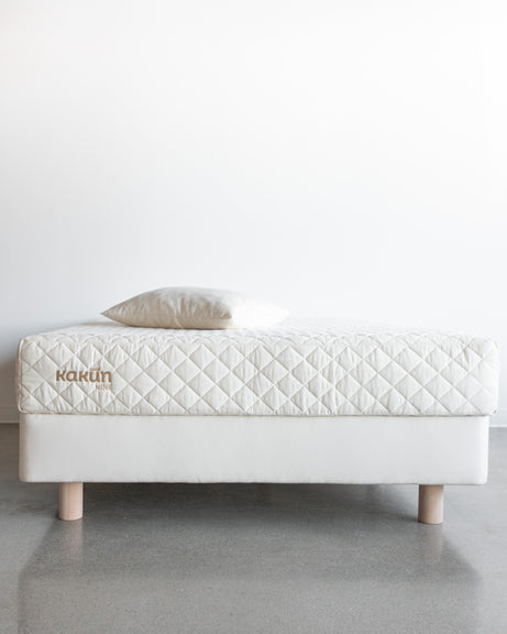 Front view of a 9 inch Organic Mattress with Kakun logo with an organic pillow on top of an 8 inch Obasan foundation bed frame