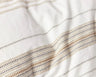 Lobos organic cotton duvet cover with yarn dyed stripes of small geometric patterns. Soft white with hazel. From Coyuchi.