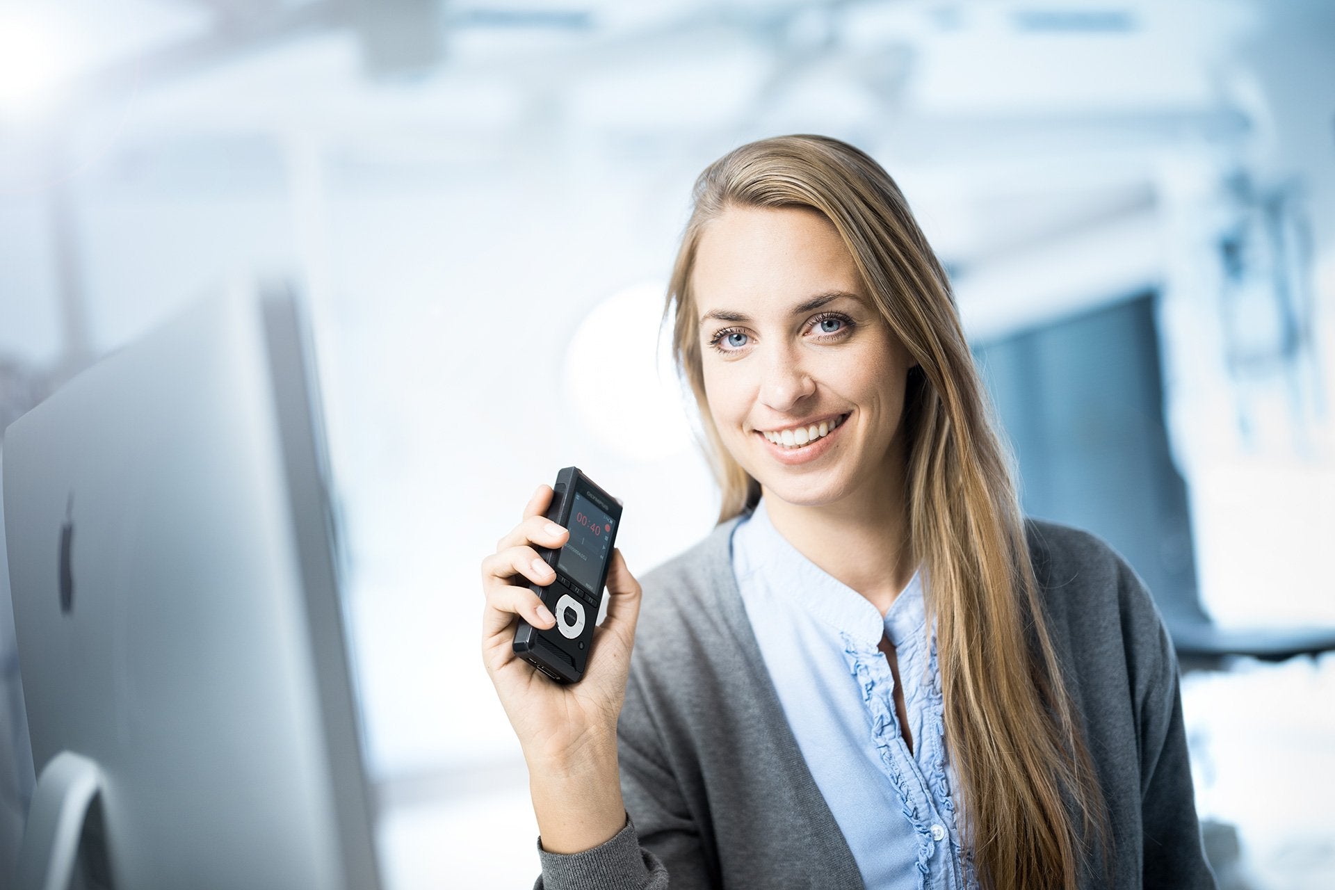 lawyer holding Olympus Voice Recorder