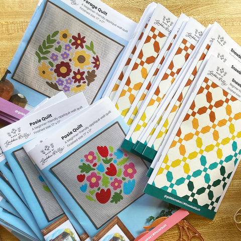 A stack of quilting pattern booklets