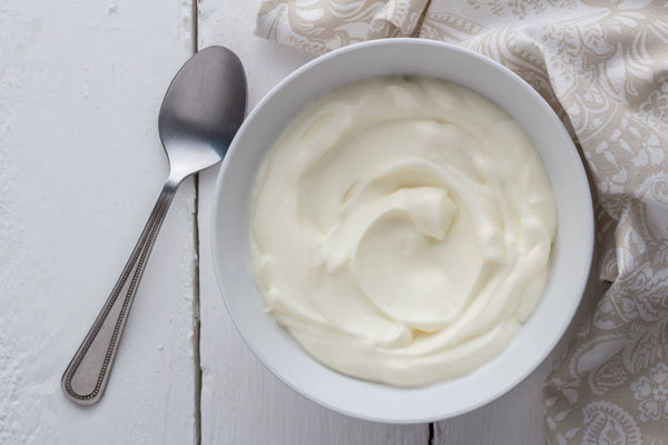bowl of greek yoghurt on table with spoon