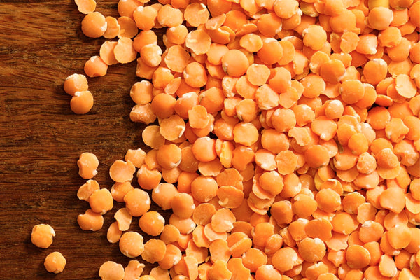 group  of red lentils in a brown tabletop