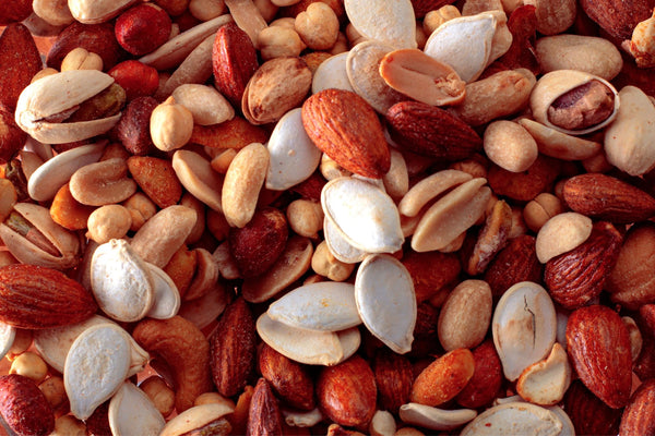 up close photo of a collection of nuts including: almonds, peanuts and pistachios