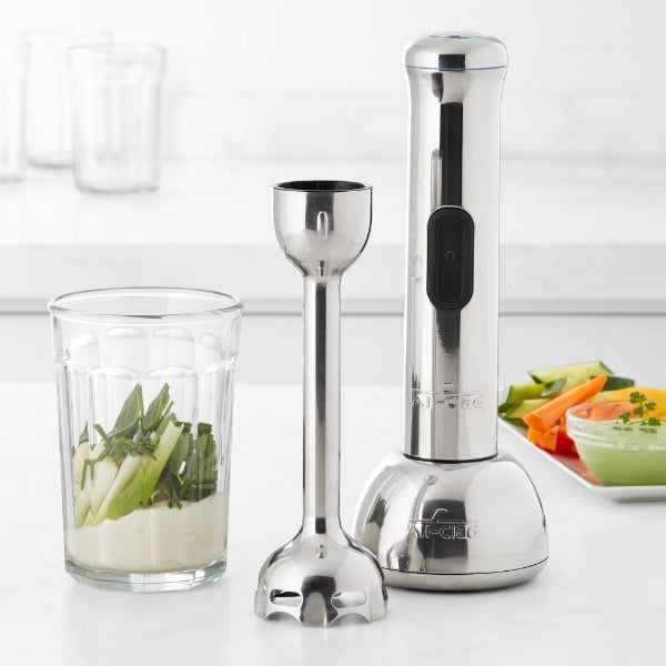 Product image of immersion blender beside a glass with ingredients prepared inside