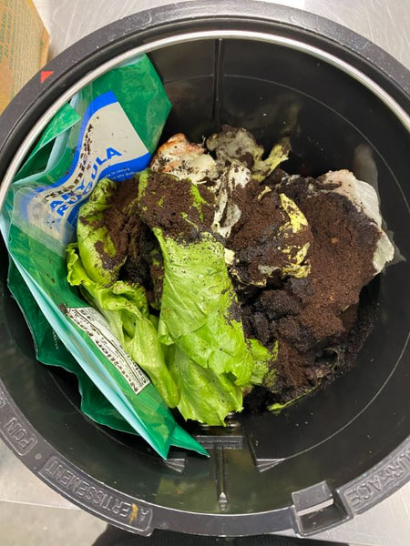 An image of Fair Earth Farms Baby Arugula Bag and food waste in lomi