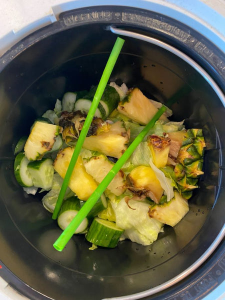 An image of Smile Beverage Werks Green Compostable Straws and food waste in lomi