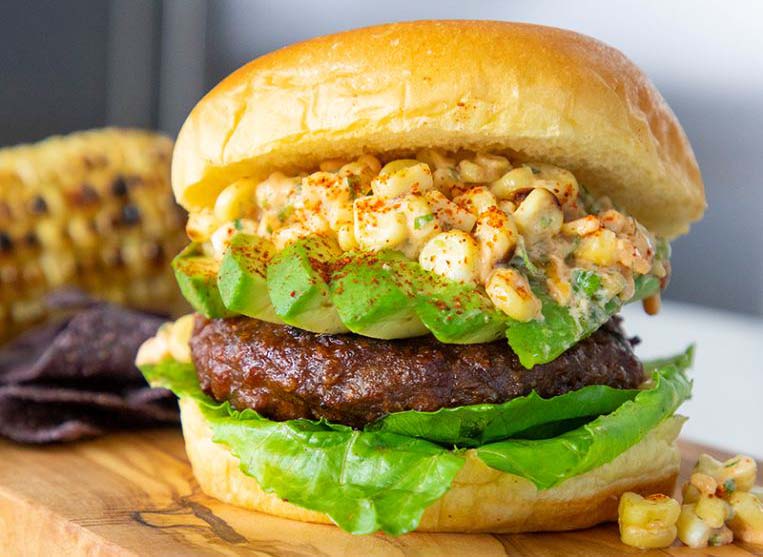 A burger made with a beyond meat patty on a cutting board