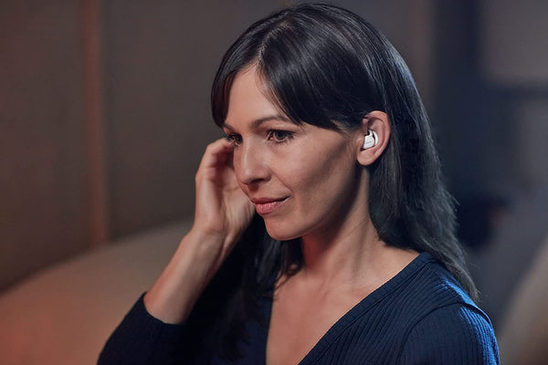 A woman with white earphones in her ears