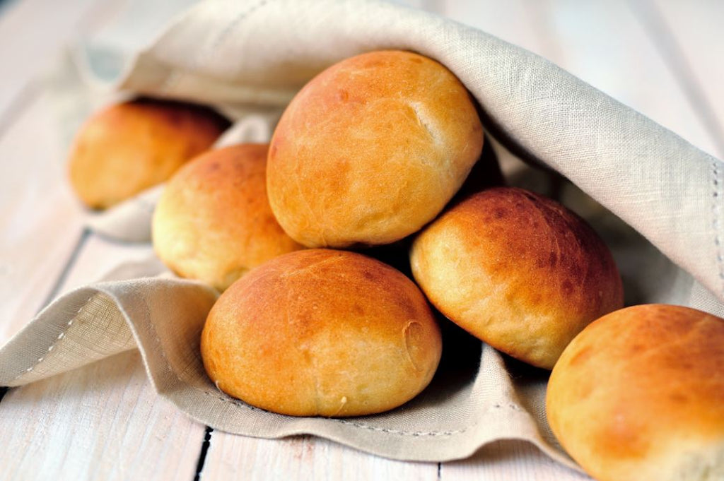 A pile of holiday bread rolls on a bread bag