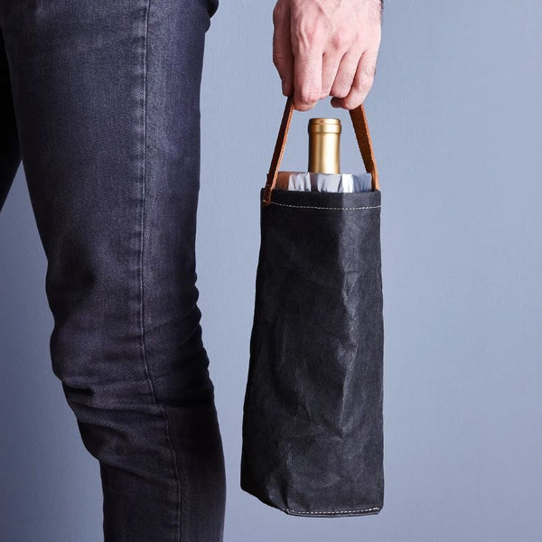 A hand holding a wine bag cooler gift