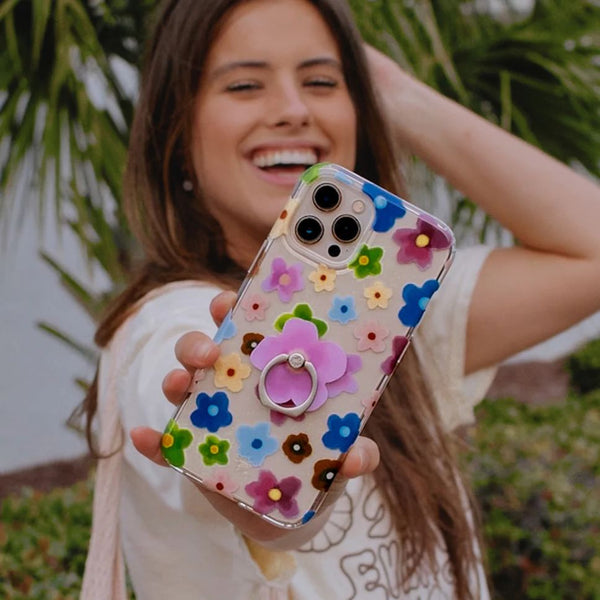 person holding a flower phone case towards camera