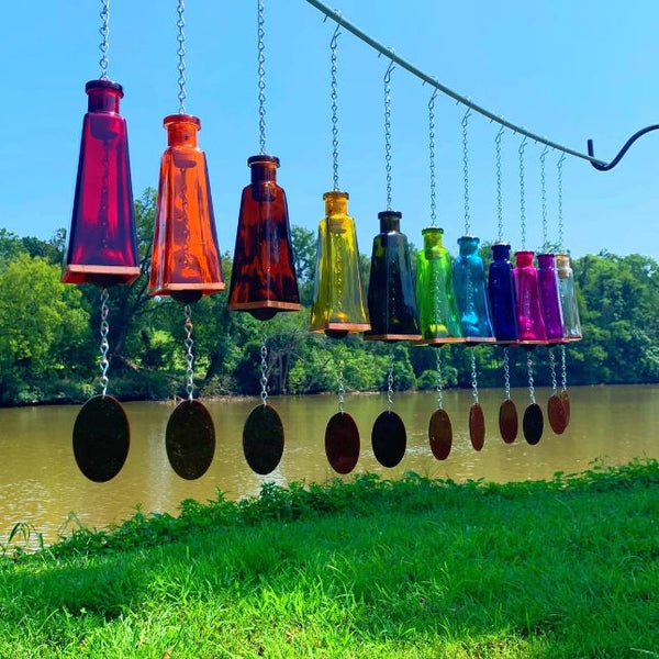 multi-color glass wind chimes hanging outdoors