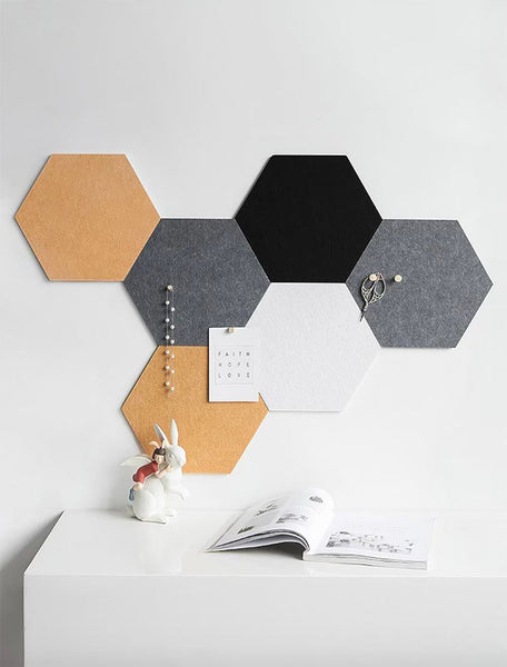 Gray, orange and black hexagons on a white wall