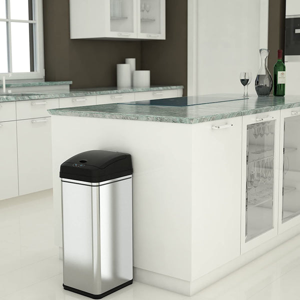 silver trash can next to a kitchen island