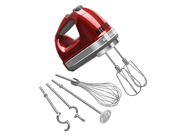 Dynamic product photo of a shiny red hand mixer with all four extra attachments splayed out in a fan shape around the mixer