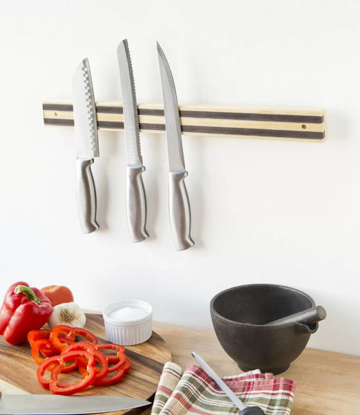 Magnetic knife holder mounted on kitchen wall