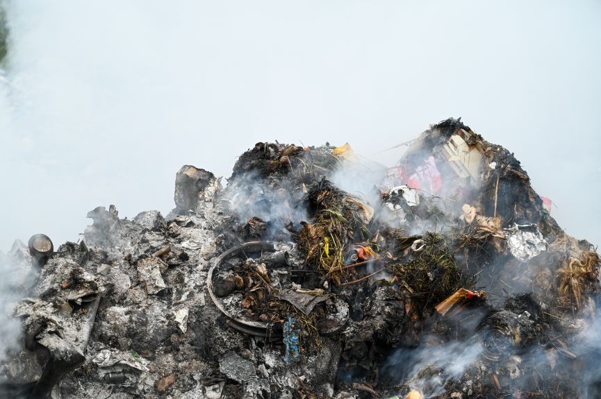 pile of burning garbage at a landfill