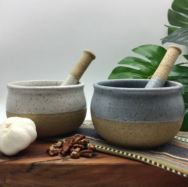 white and gray pottery mortar and pestle