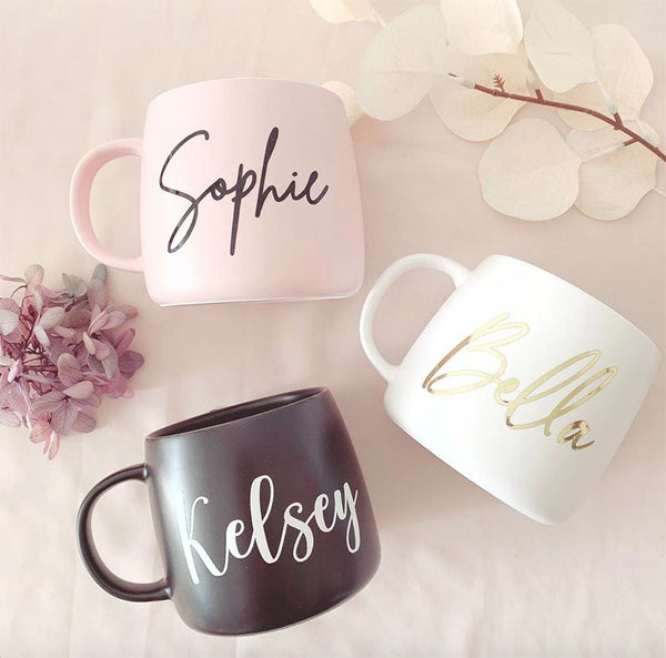 Three mugs with the names Sophie, Bella and Kelsey on them