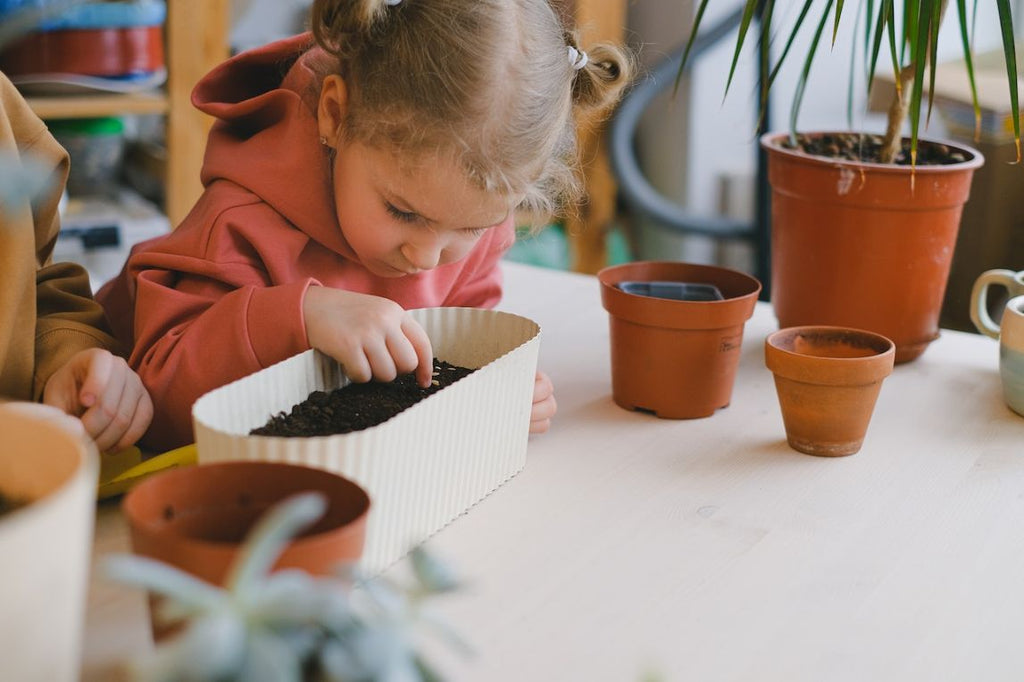 Young girl learns to plant seeds