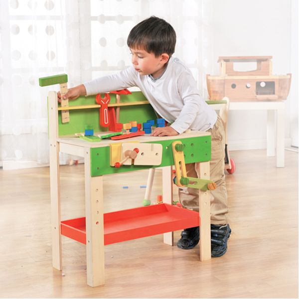 A young boy playing with an eco friendly carpenter set