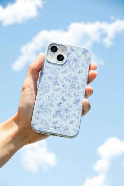 person holding a blue iphone case in front of a blue sky