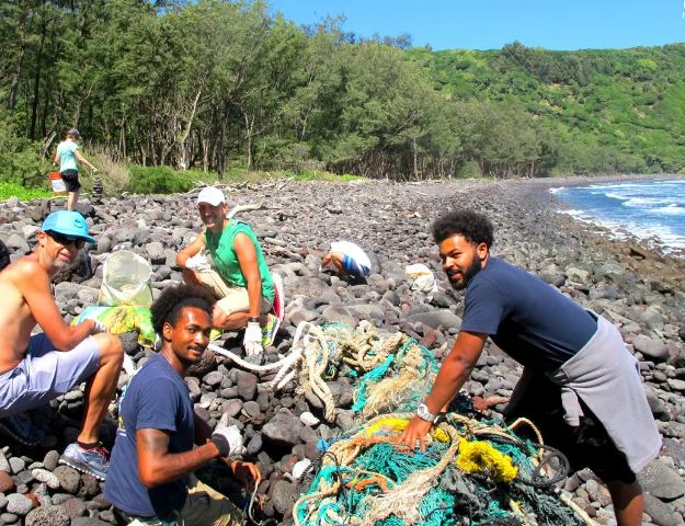 A group of people cleaning up ocean pollution