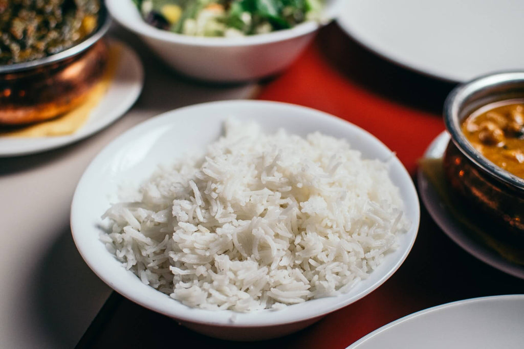 A white bowl of rice in the table