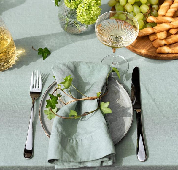 A light blue napkin on a plate on a decorated table