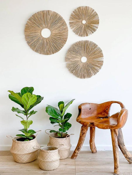 Three various-sized belly baskets next to a wooden chair