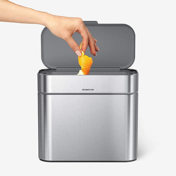 silver food waste caddy with hand