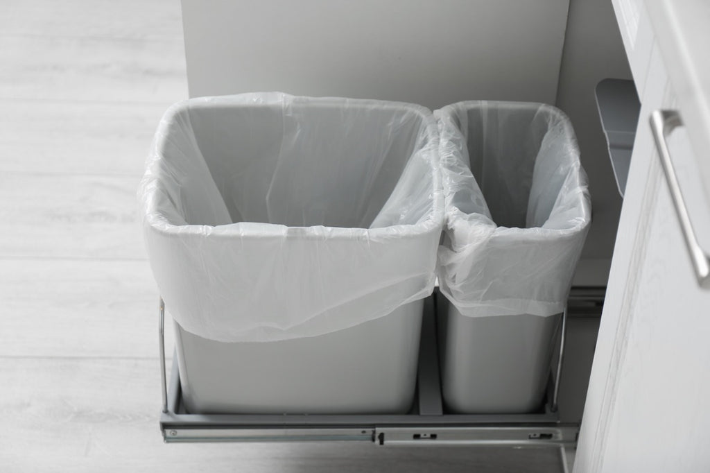 Two small and gray kitchen garbage bins