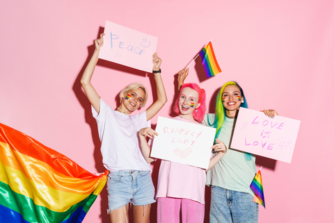 group of teen girls supporting lgbt right with rainbow flags and signs