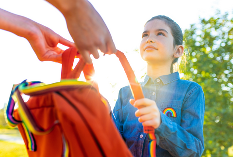 young girl with rainbow backpack