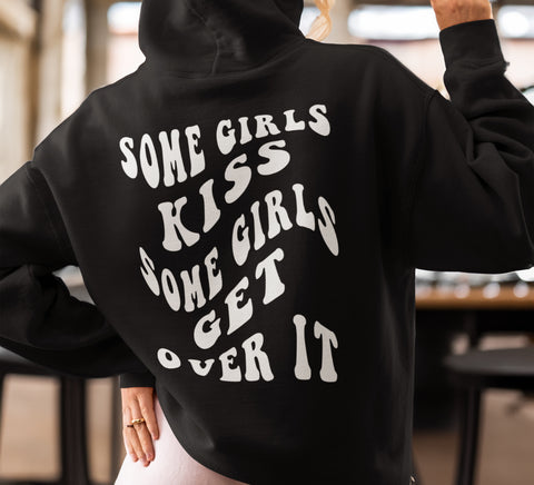 Girl wearing lesbian pride hoodie that says some girls kiss some girls get over it