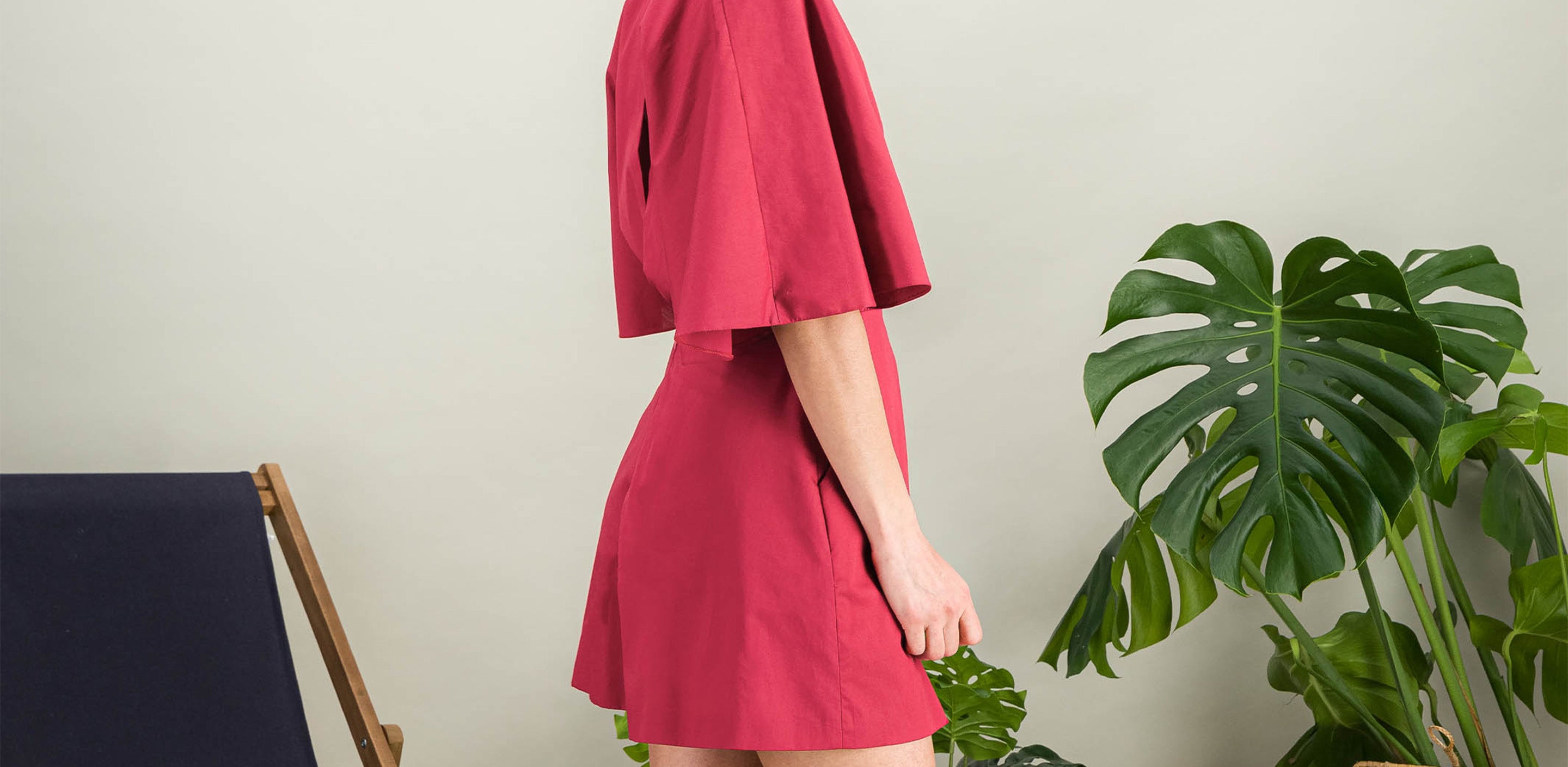 Flared raspberry pink cotton poplin playsuit with butterfly sleeves