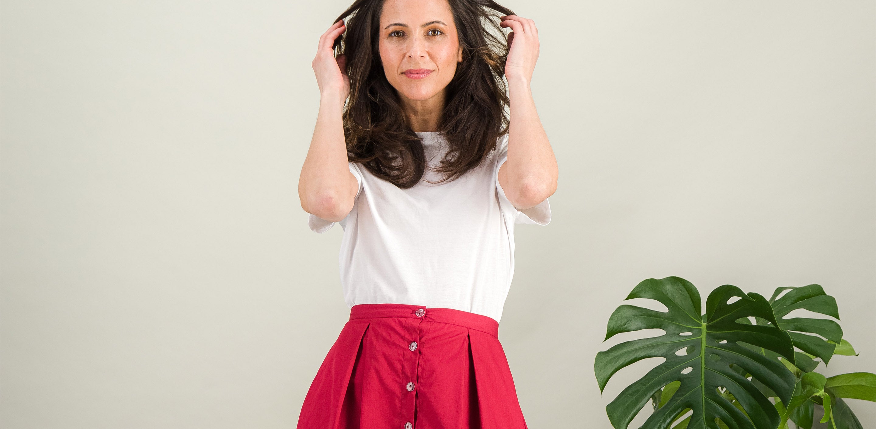 simple white cotton top with flared pink cotton skirt for a casual look