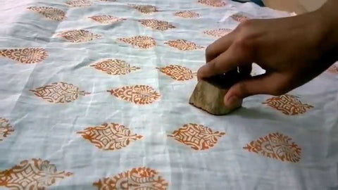 Hand printing fabric with wood block