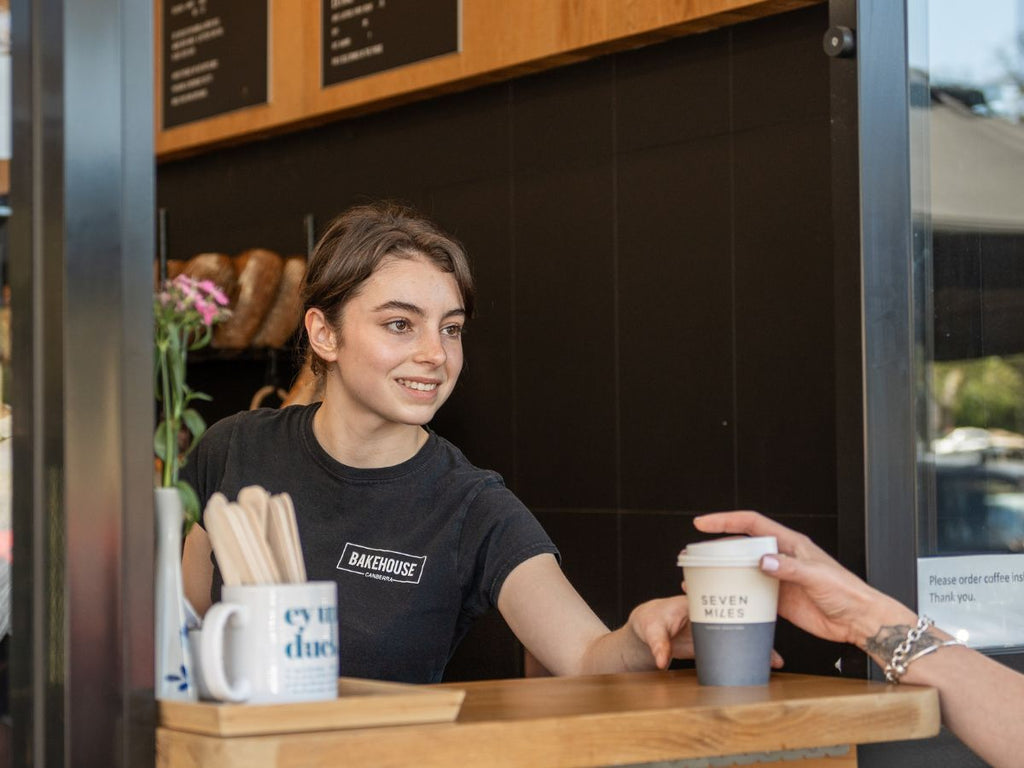 barista serving coffee to a customer