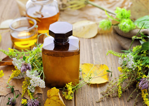 A classic example of an herbal syrup: bottle of syrup, honey and herbs.