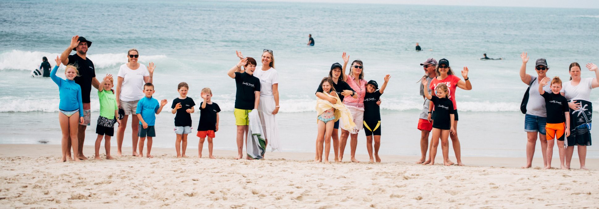 SalTy Souls team and young people on the beach waving