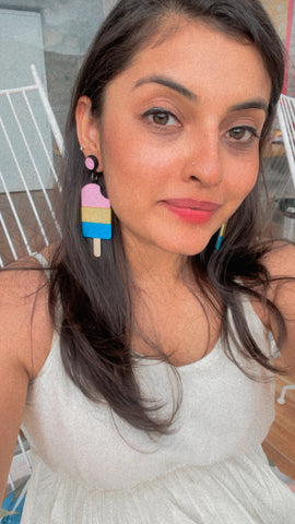 Founder of Nian by Nidhi - Nidhi Gupta - wearing Popsicle Earrings on a white dress