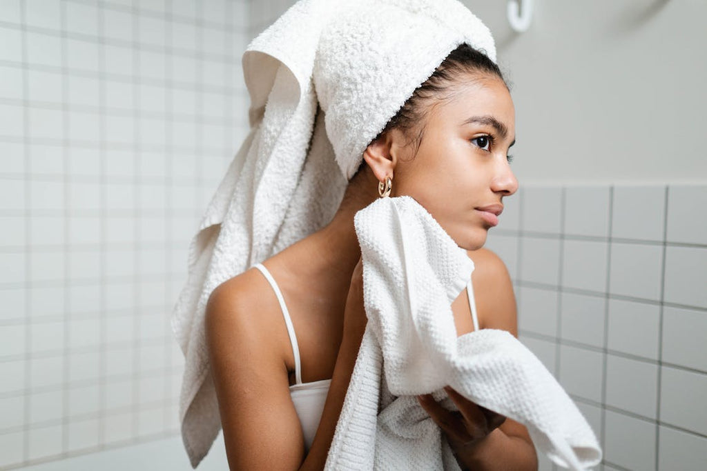 woman drying face with towel