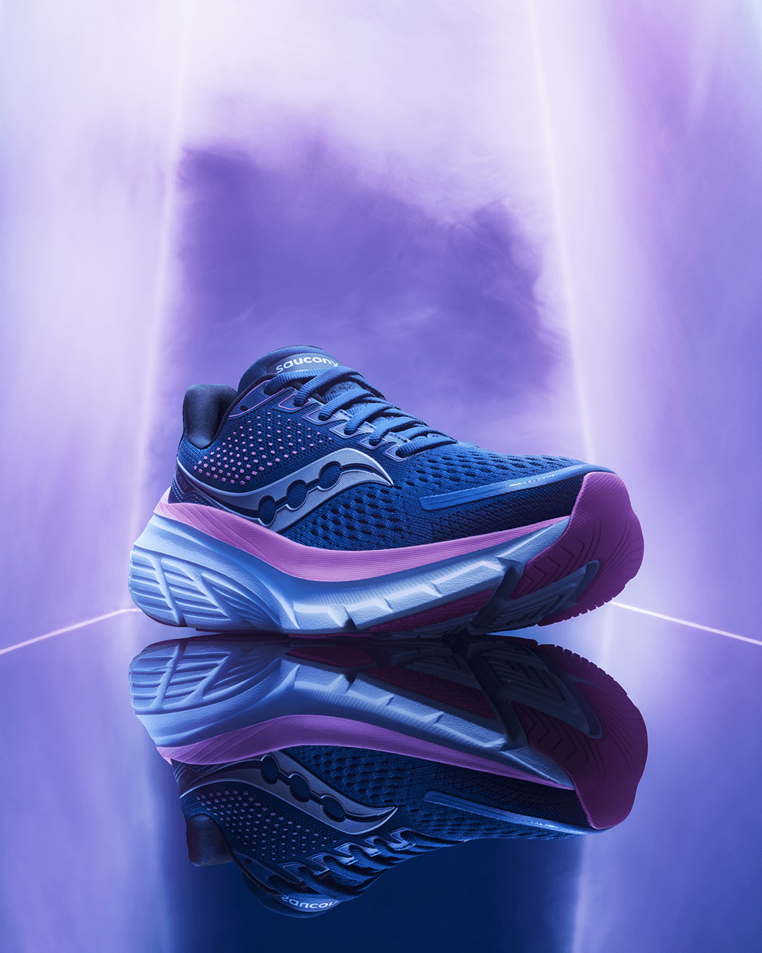 Women's Saucony Guide 17 running shoe in navy/purple colourway against purple-lit background